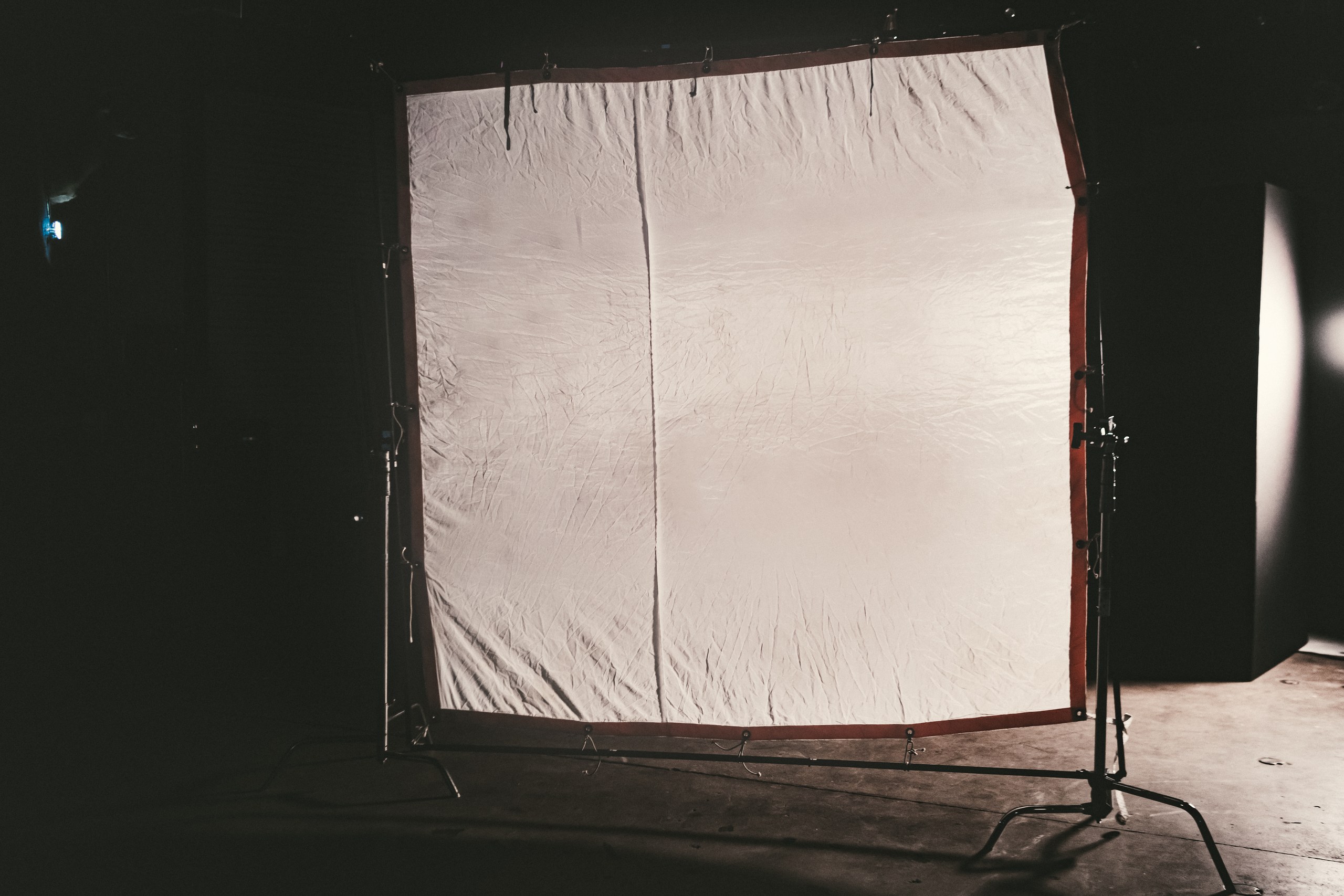 Gear 13 Large diffusion frame rigged on stands across a darkened studio stage