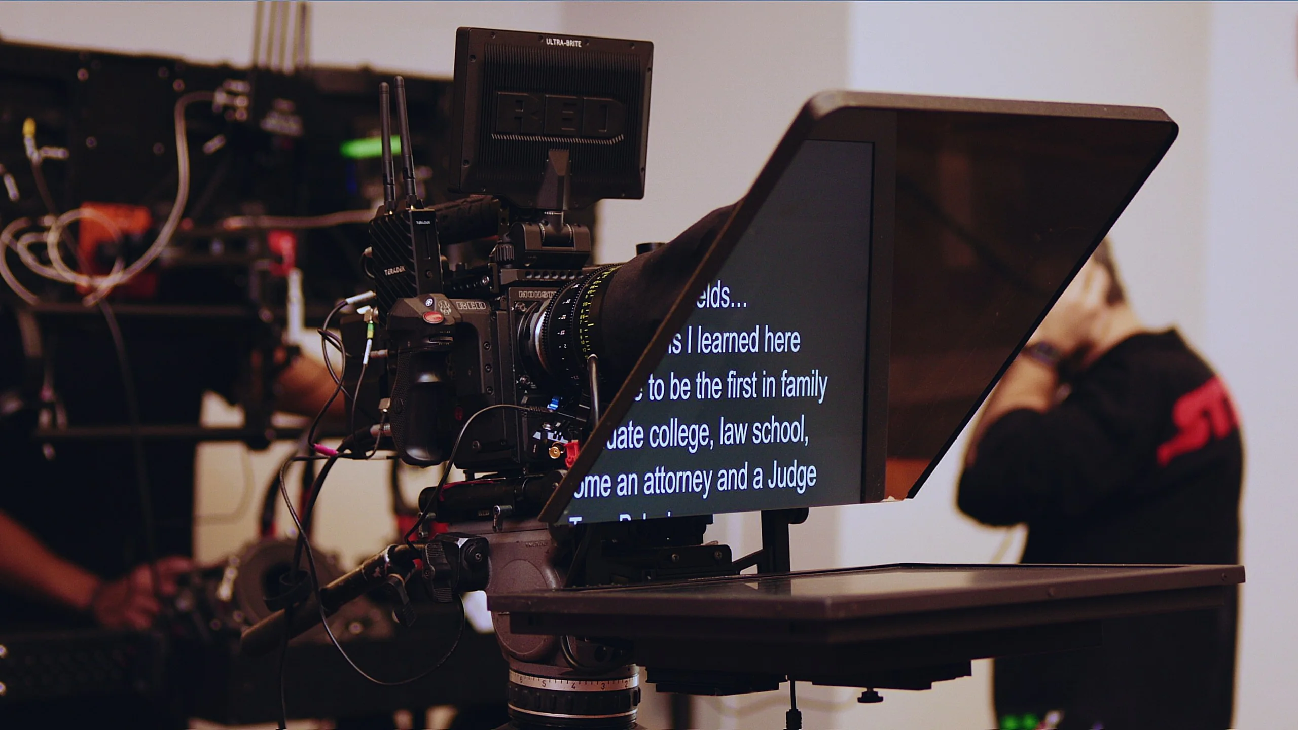 Production Gear 37 RED cinema camera rigged with a Prompter People teleprompter reading a script