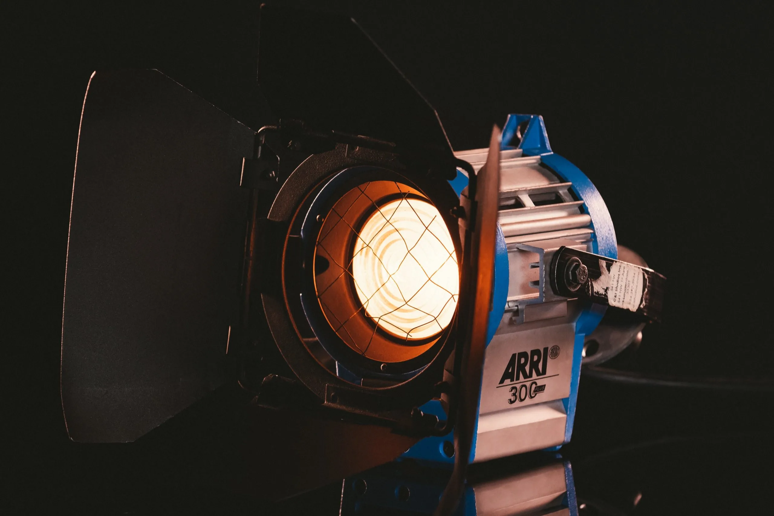 Lighting 10 ARRI 300 tungsten fresnel lit on black in the C&I Studios lighting inventory