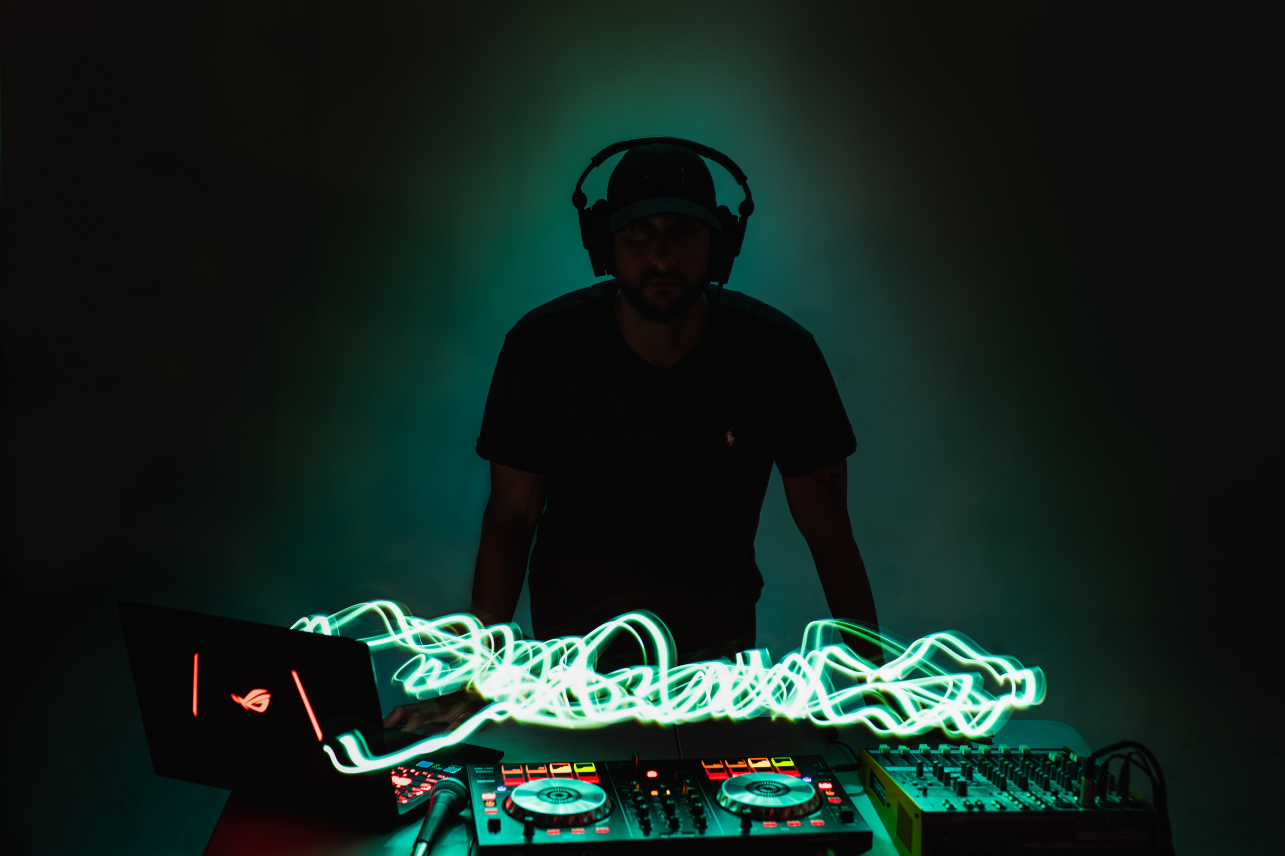 Lighting 7 DJ lit with a teal colour wash and a long exposure light trail at C&I Studios