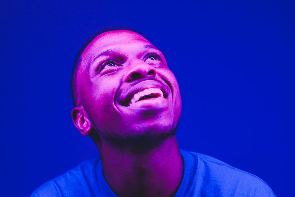 Lighting 4 Laughing portrait lit with a magenta key against a deep blue background