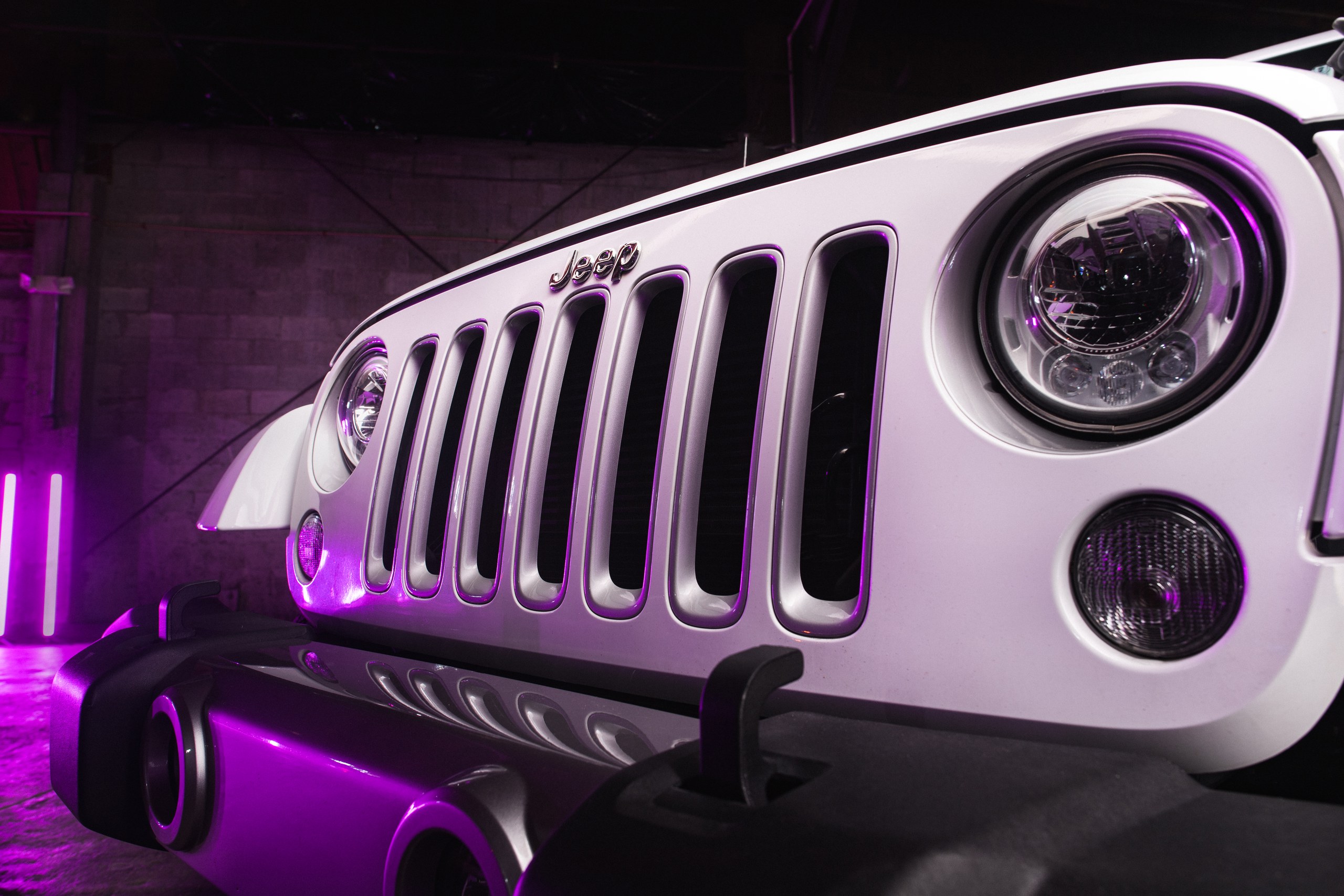 Lighting 8 Jeep grille picked out with magenta accent light in a studio