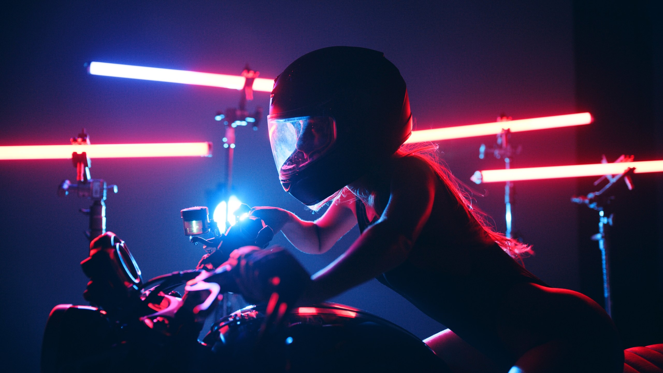Lighting 9 Motorcycle rider lit entirely by red tube fixtures on stands with a blue accent