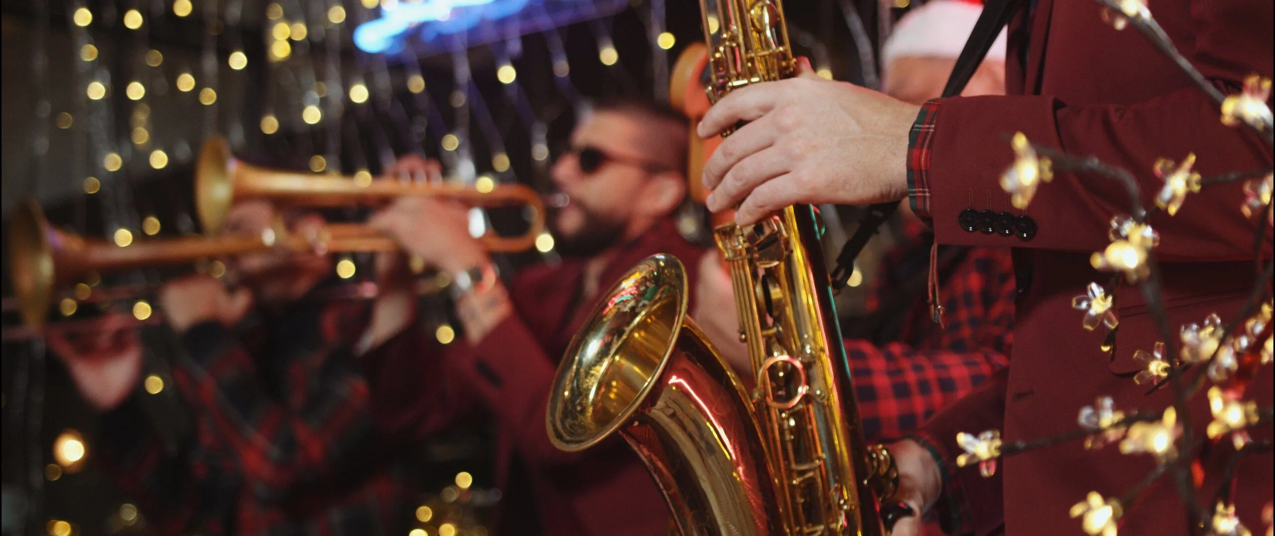 Brass section performing on the night set of the Cris Cab Feliz Navidad music video