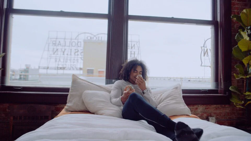 Ethx 10 Talent on a loft bed set beside a window during a beauty campaign shoot
