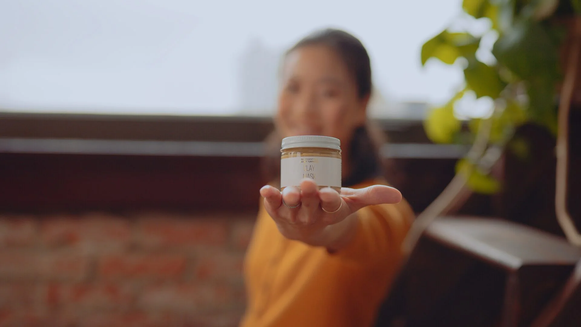 Beauty brand video production close up of a clay mask jar held to camera