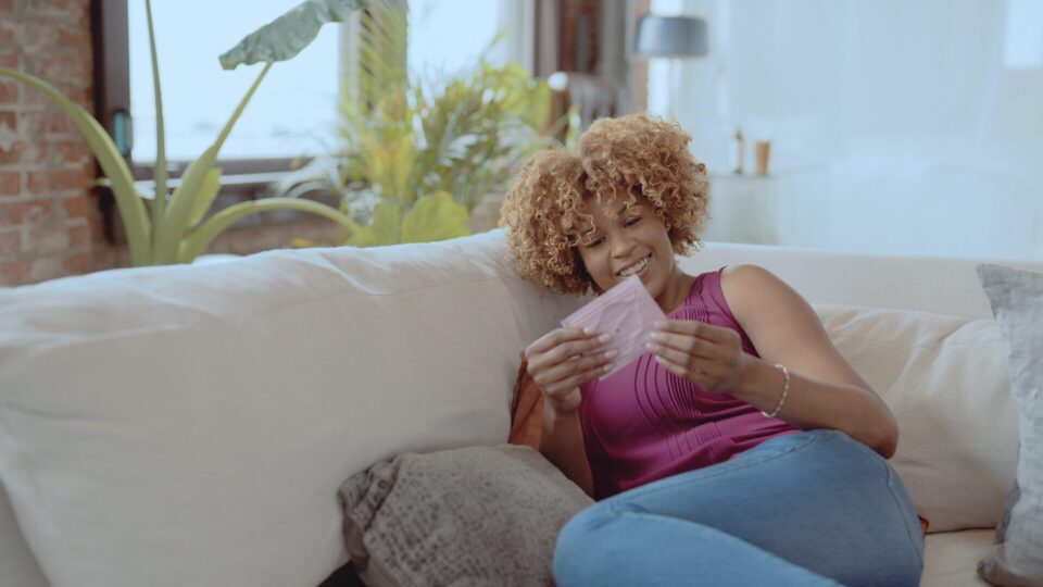 Ethx 9 Talent with a lip mask on a couch set