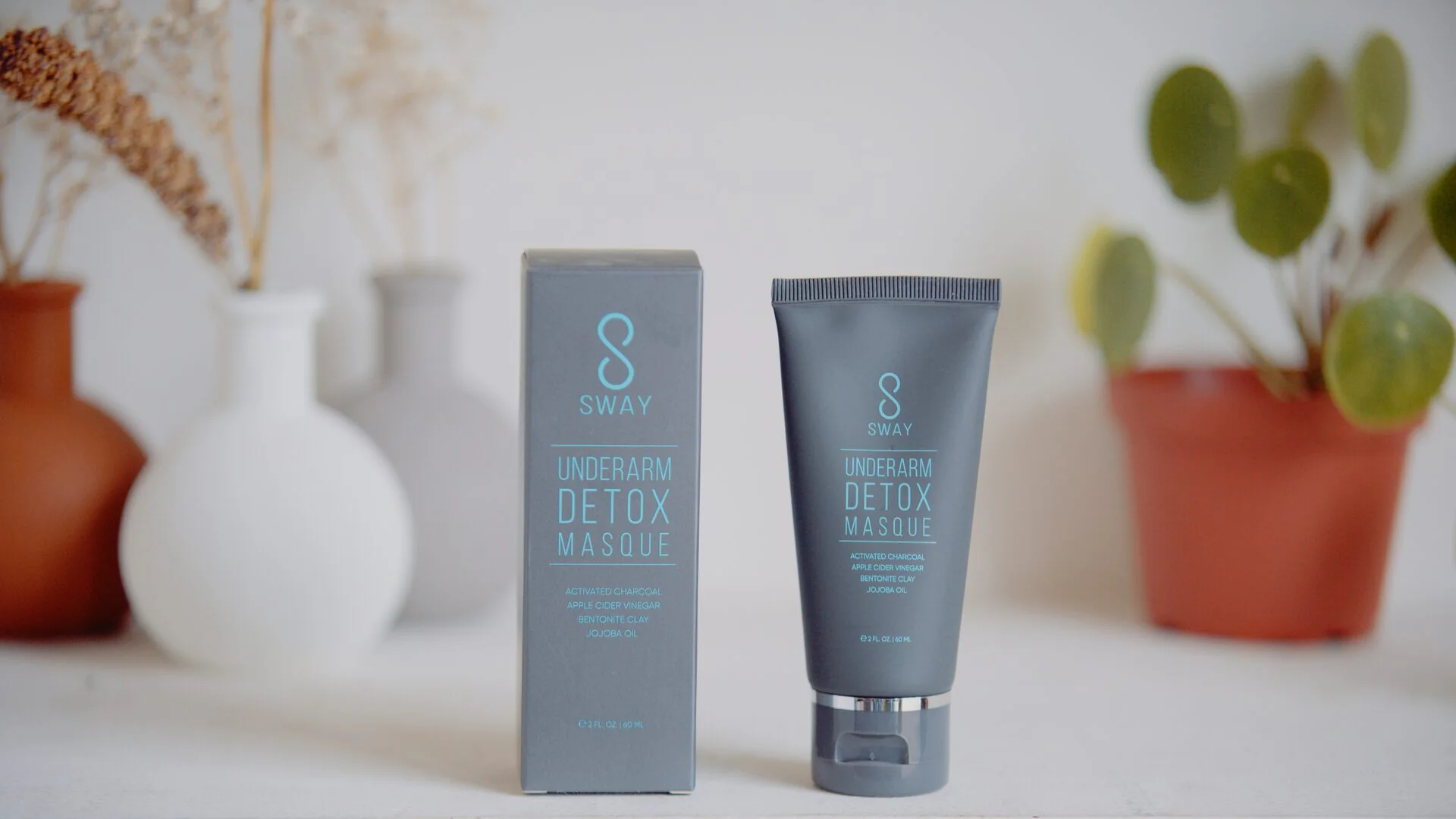 Beauty product still life of an underarm detox masque carton and tube