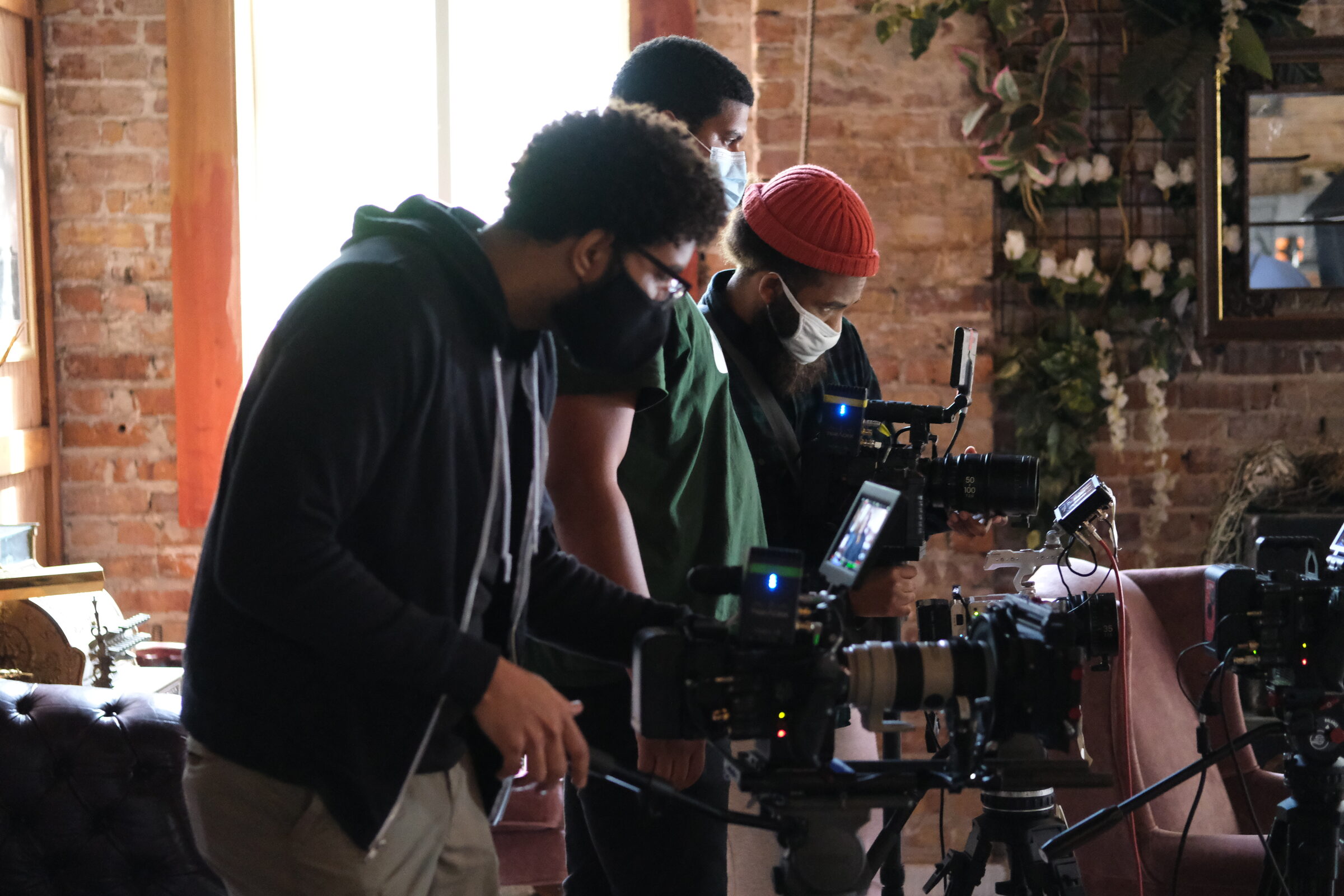 Fund Black Tech 2 Three crew building a camera setup for a documentary interview