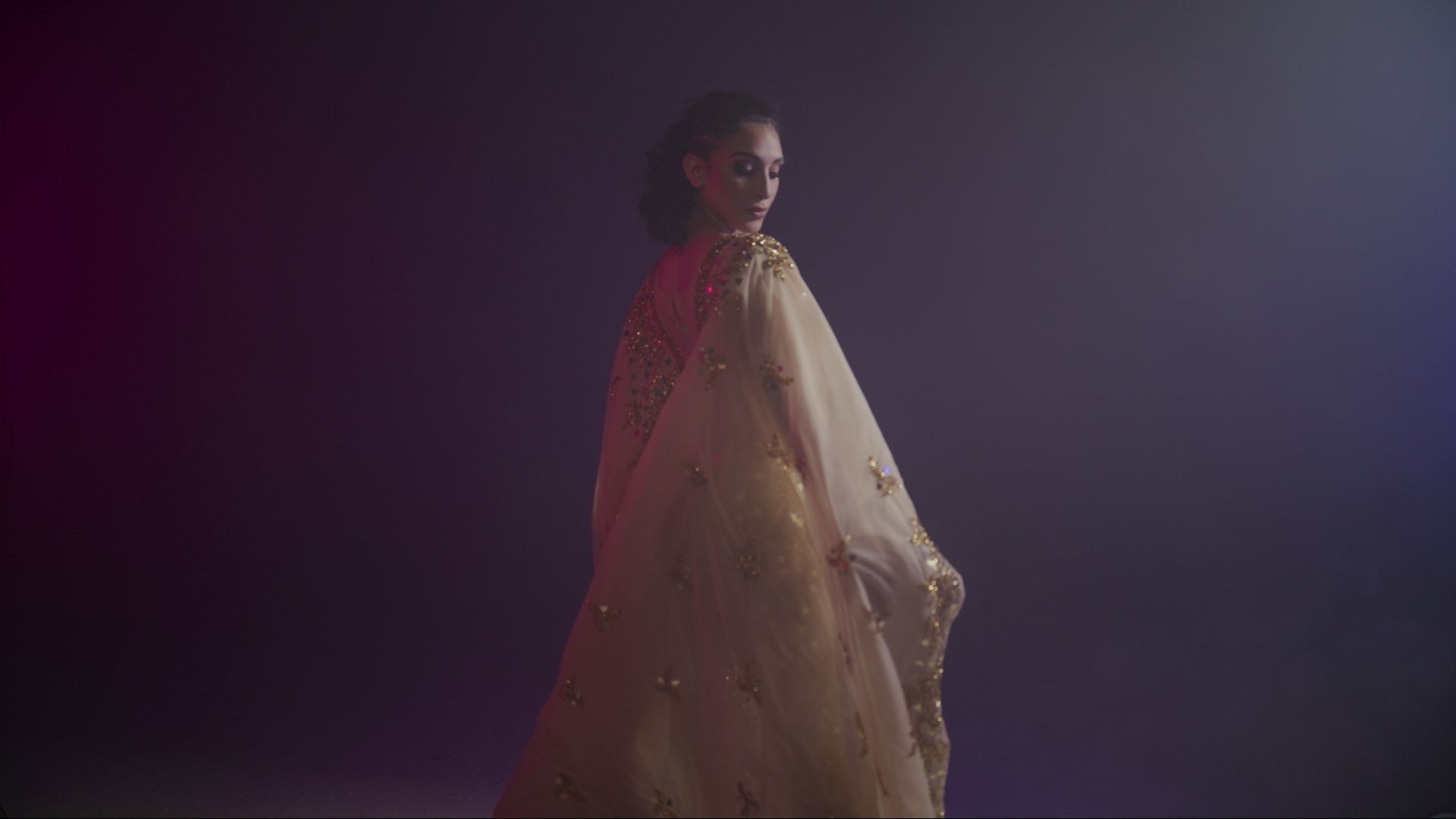 Dance video production dancer with a flowing veil under studio light