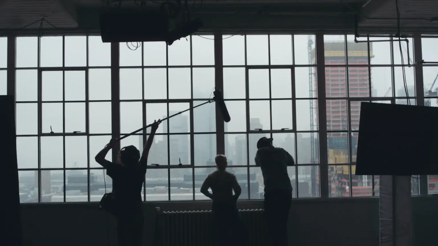The Cities We Shoot In and Why Brands Pick Each 5 Crew silhouetted at a window wall during a national video production company shoot