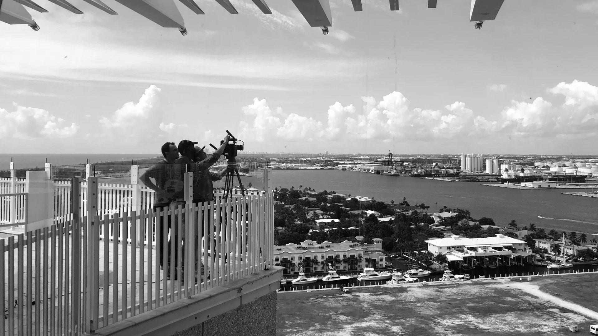 The Cities We Shoot In and Why Brands Pick Each 2 Two person C&I Studios crew shooting from a rooftop above the water