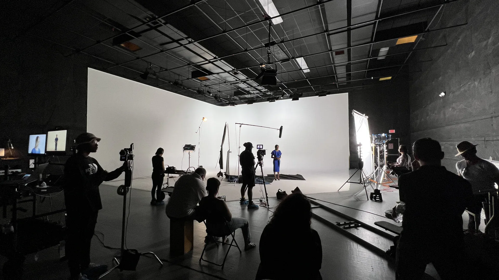 Behind the Scenes of a Brand Photo Shoot 3 Full crew and client watching from the monitors on the white cyc stage during a brand photo shoot at C&I Studios