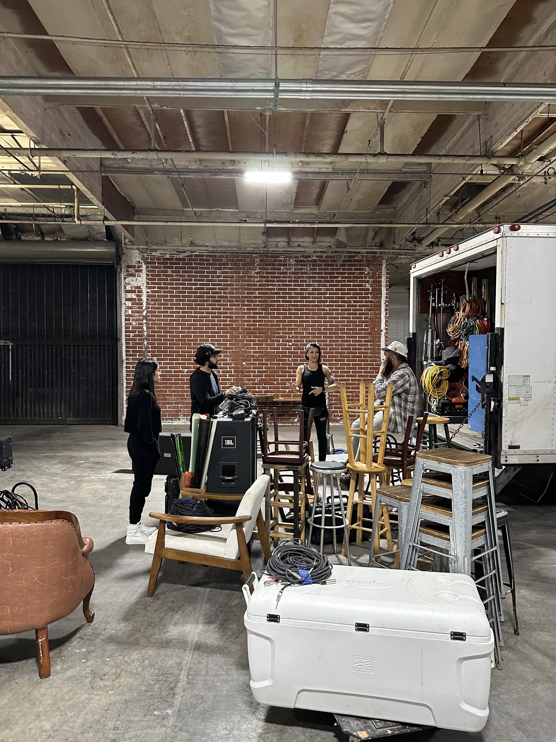 Grip Trucks 13 C&I Studios grip crew talking through the load at the back of the grip truck on set