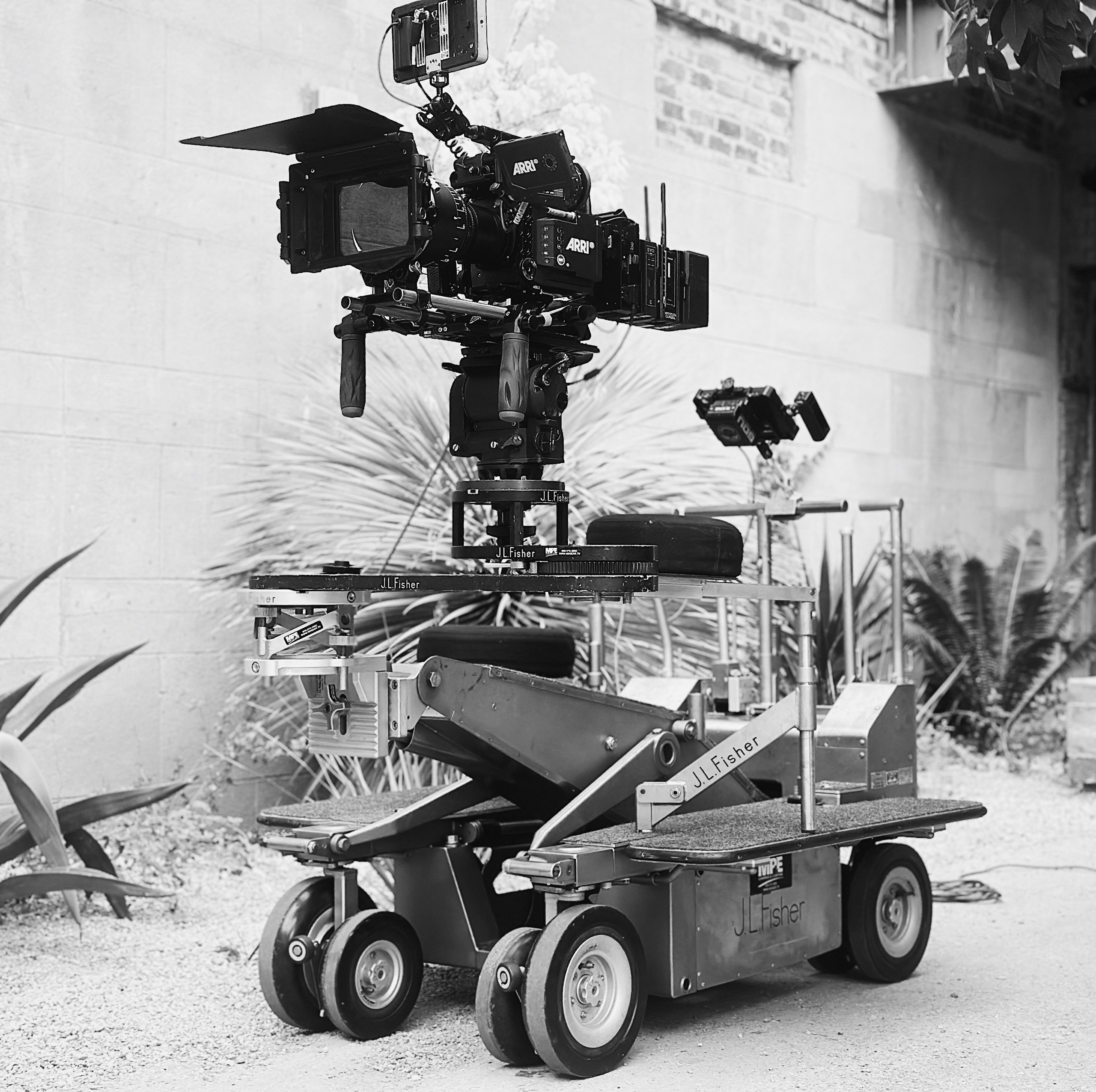 Hawk Lenses 2 ARRI Alexa Mini LF with Hawk anamorphic glass on a Fisher dolly outside a brick location