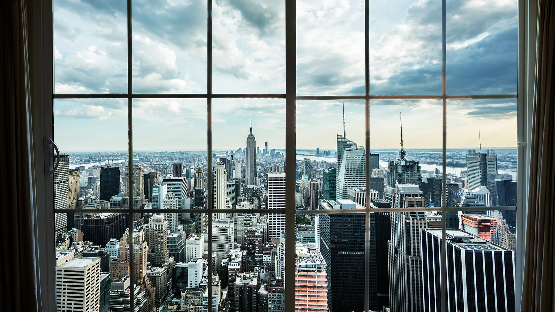 How Much Does Video Production Cost in New York? 3 Midtown Manhattan skyline through a high floor window, an alternative to a restricted drone shot