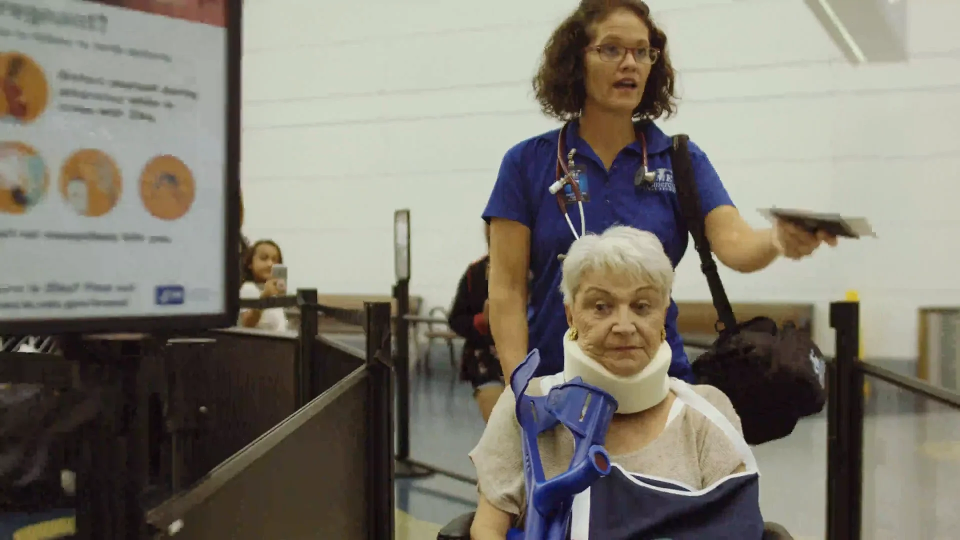 CME flight nurse escorting a patient through airport security