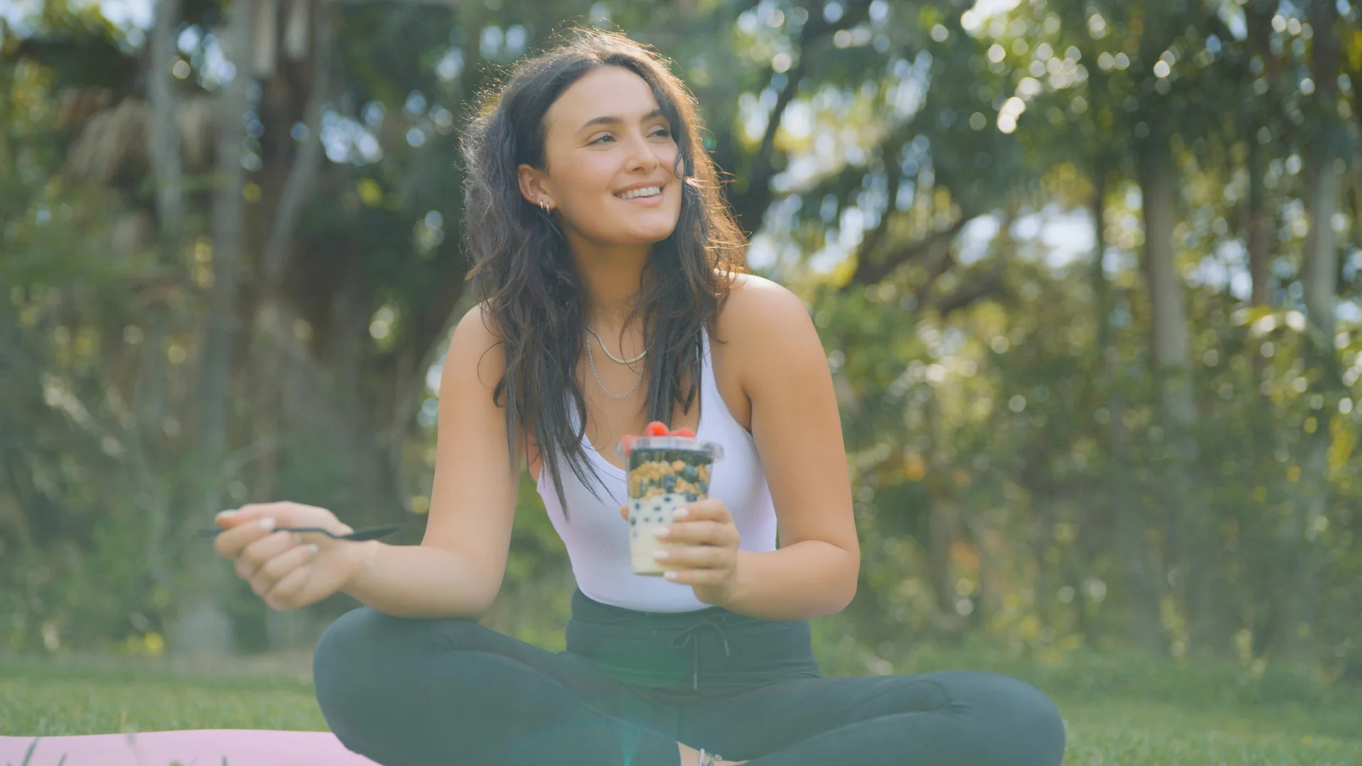 What a Corporate Video Actually Delivers for a Brand 3 Woman on a yoga mat outdoors holding a cup during a lifestyle shoot by C&I Studios
