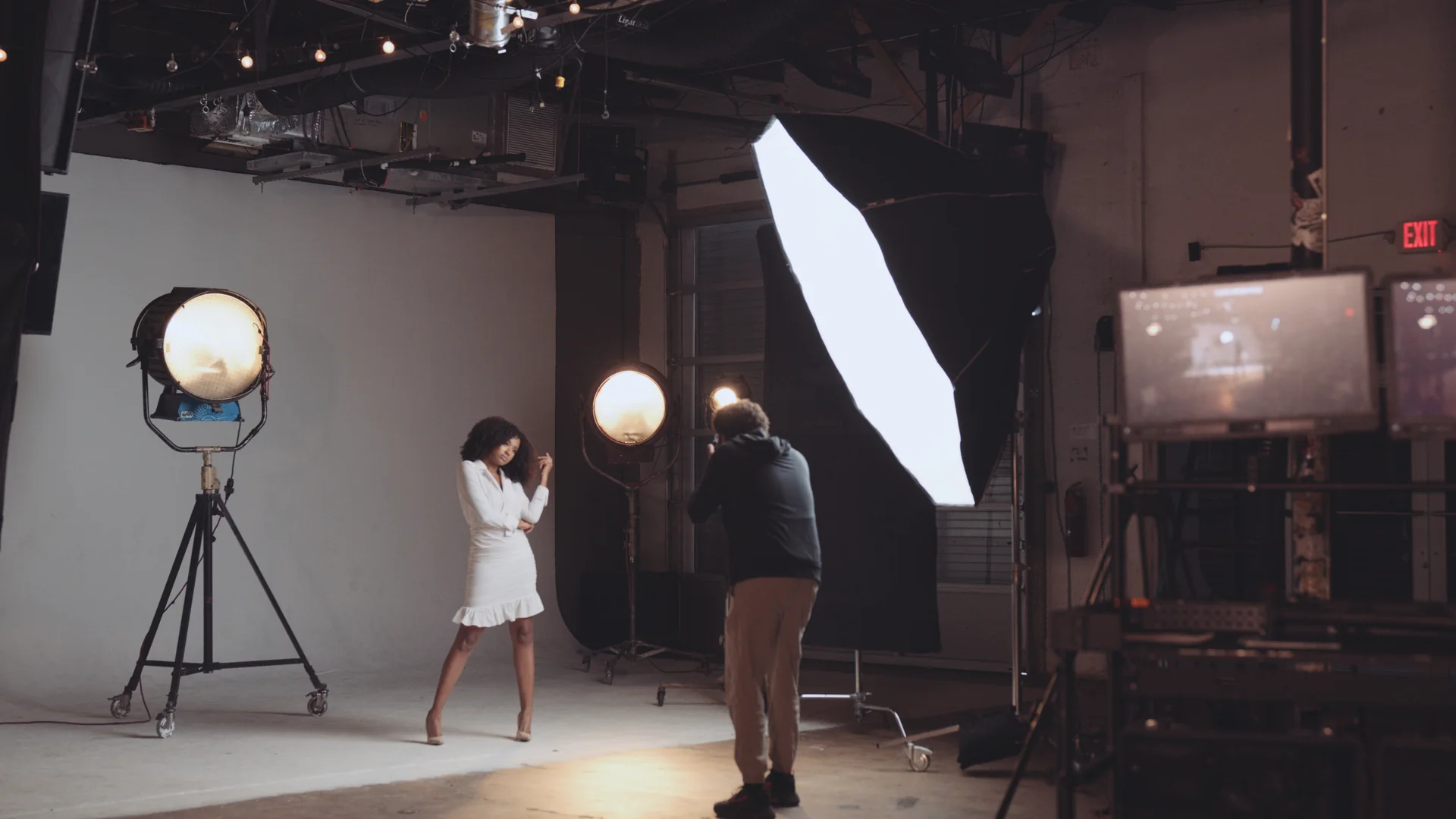 What a Corporate Video Actually Delivers for a Brand 1 Photographer shooting a model on the white cyc stage at C&I Studios with large lights and monitors on set