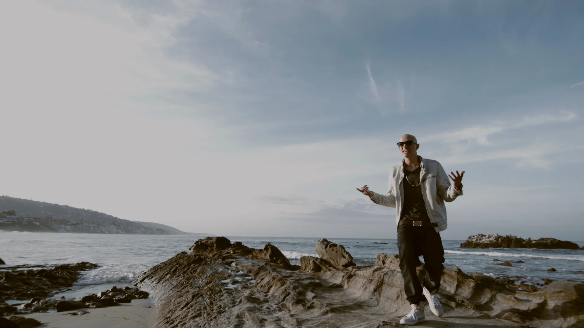 What a Music Video Production Budget Covers 3 Artist performing on coastal rocks by the ocean in a music video shot on location by C&I Studios
